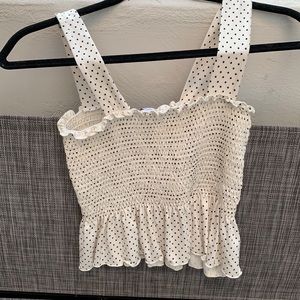 Poka dot tank top. Kinda cropped but just shows a little skin.